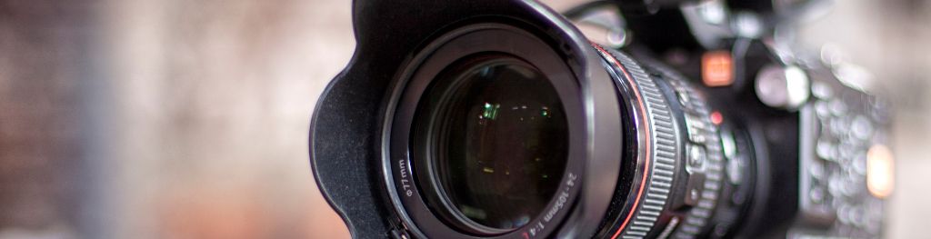 A close up of the lens of a broadcast-quality TV camera