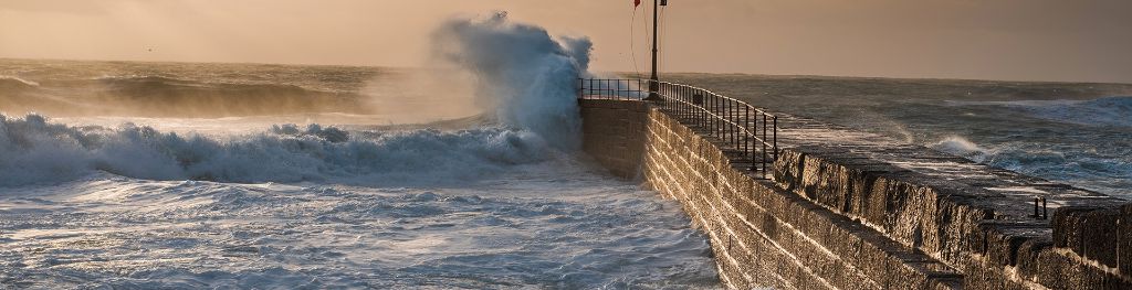 Storm waves crashing against a harbour wall