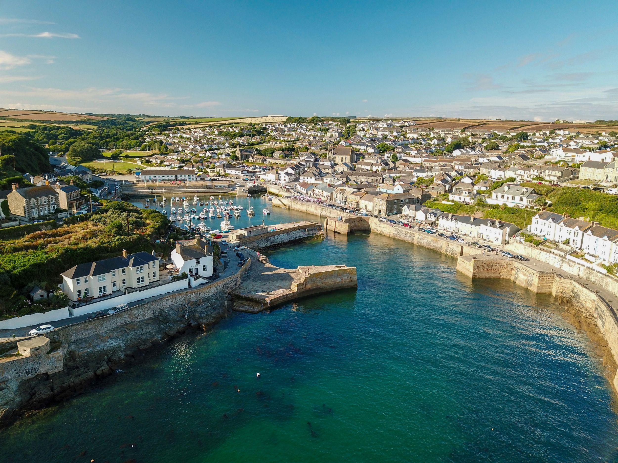 Landscape of UK town with waterway in middle and blue sky overhead