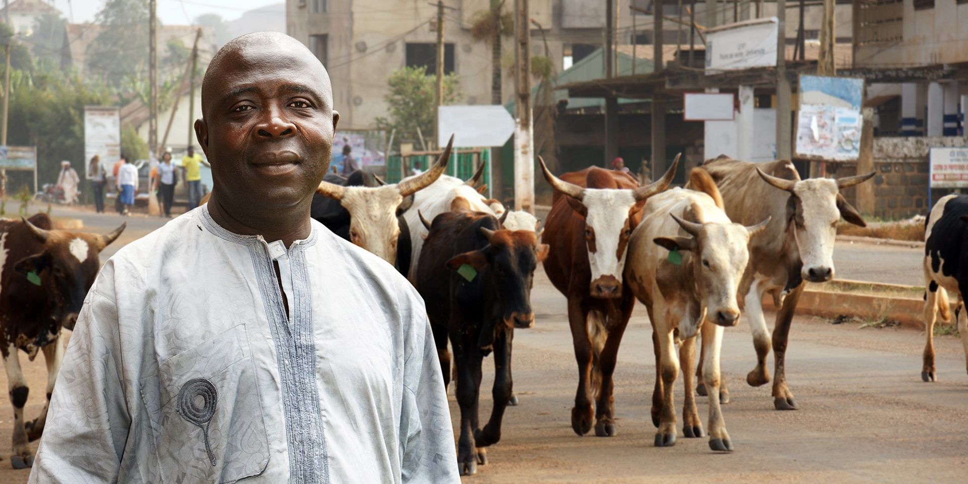 african-cattle-farmer-on-busy-city-street