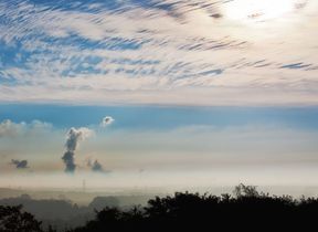billows-of-smoke-pollution-rising-into-a-cloudy-sky