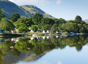 boats-and-campsite-by-a-lake