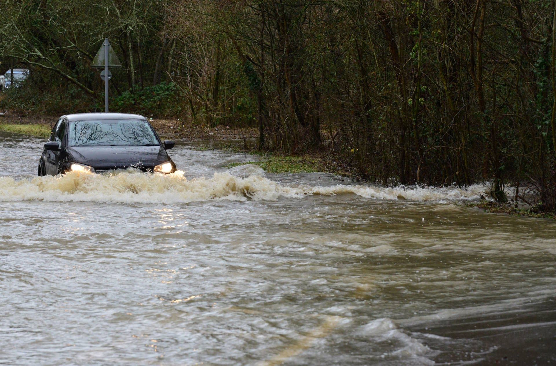 car-on-flooded-road-adobestock_310860083