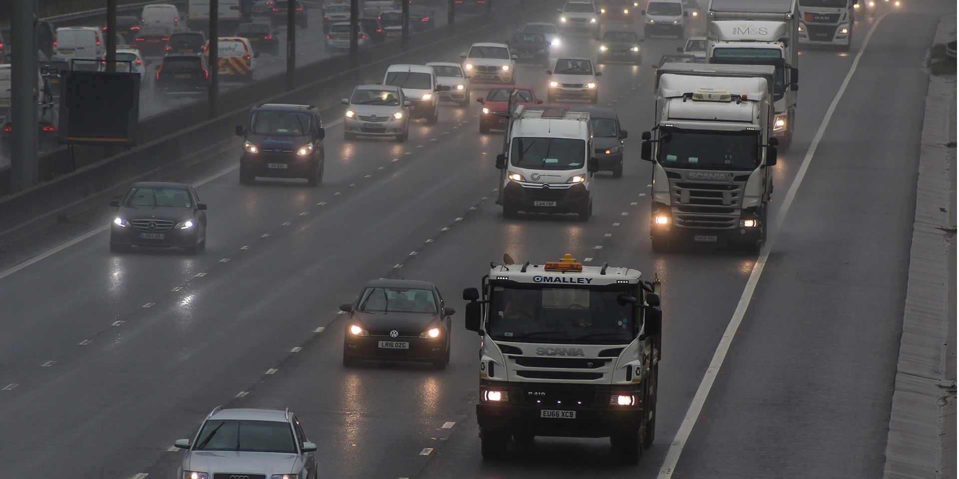 Cars and lorries on a busy, wet road