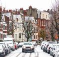 cars-parked-along-snowy-street