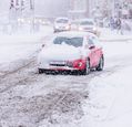 cars-traveling-in-snow-covered-city