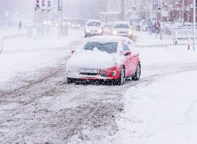 cars-traveling-in-snow-covered-city