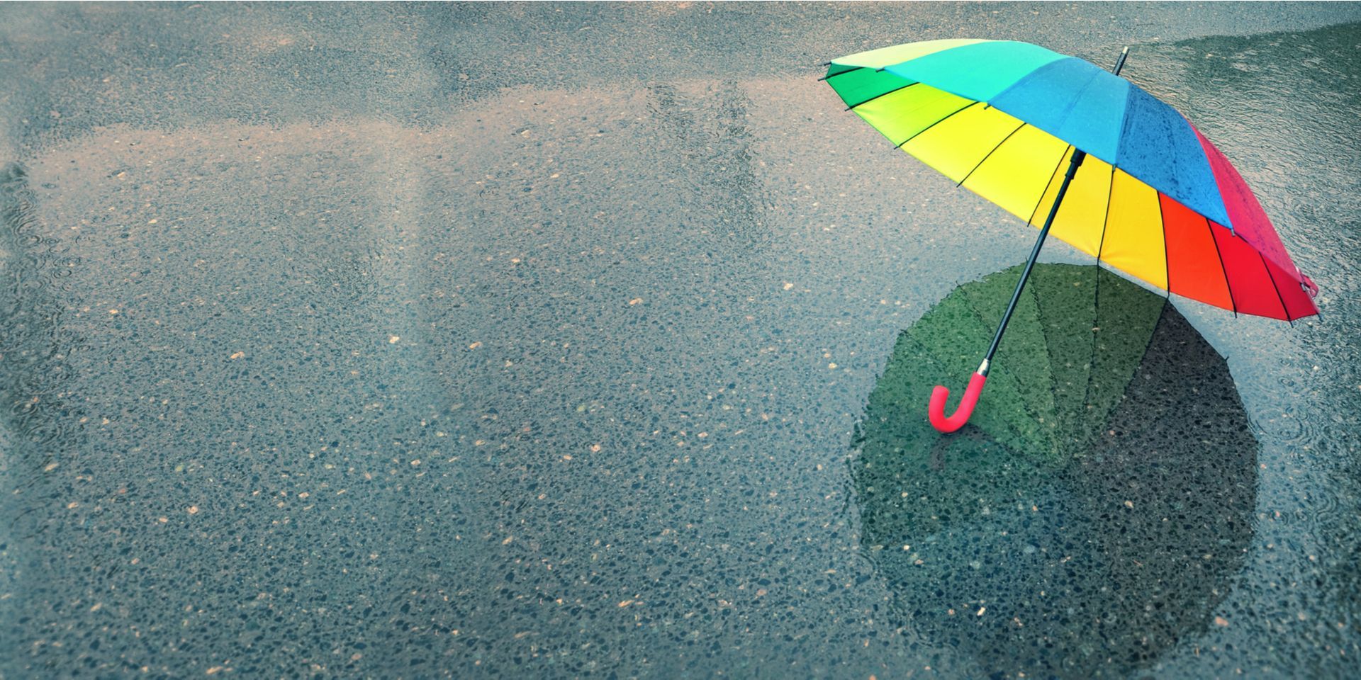 colourful_rainbow_umbrella_in_puddle