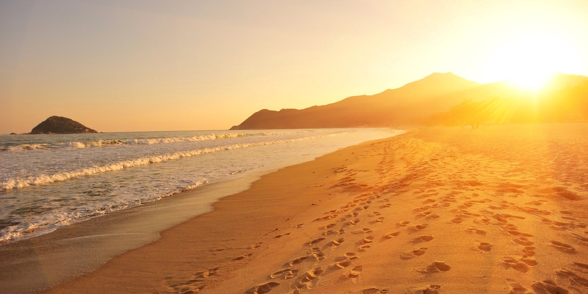 Footsteps on sunny beach