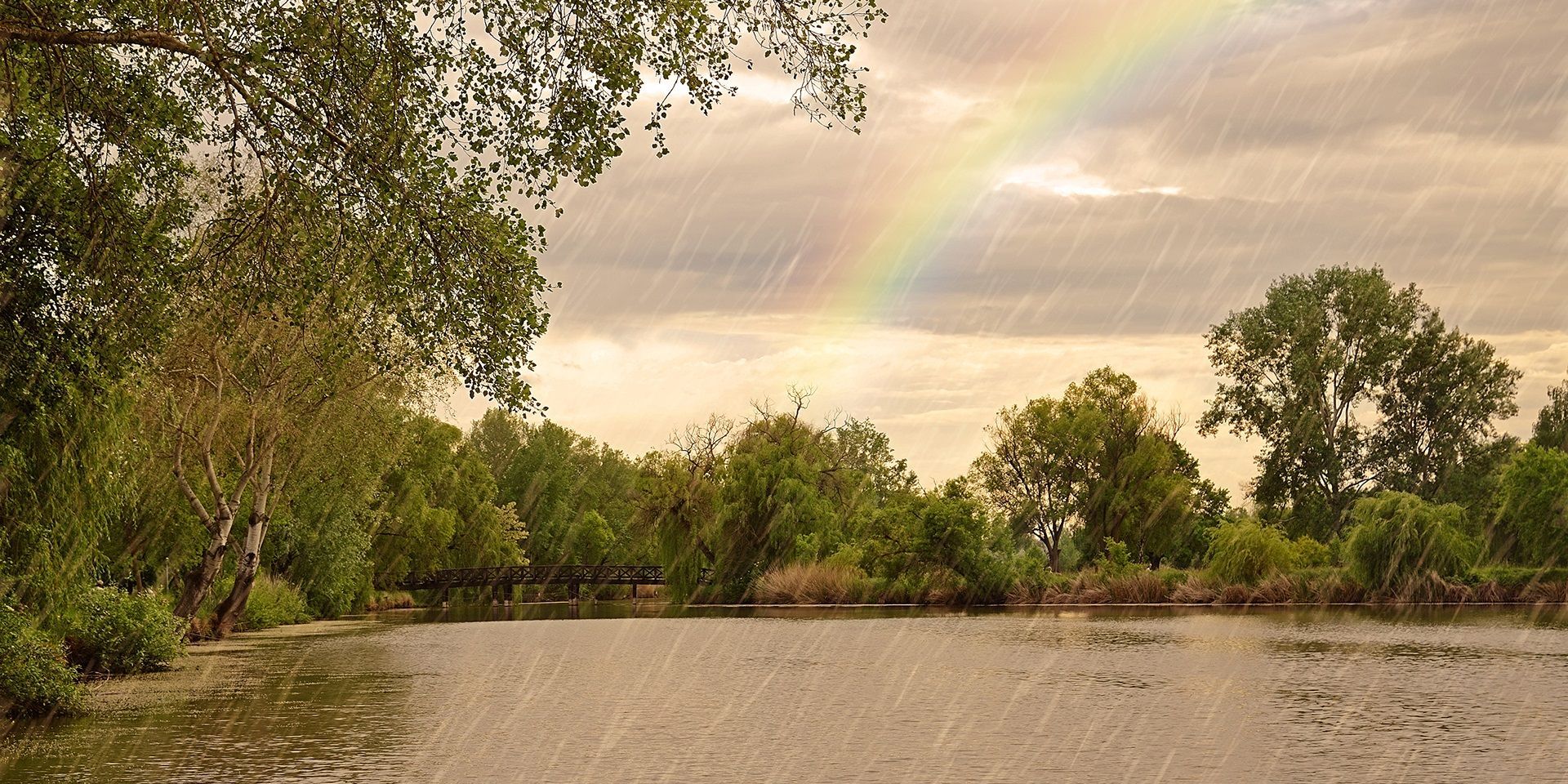 heavy-rain-and-rainbow-over-a-river