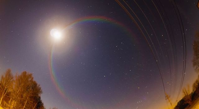 A faint moonbow at night over falling water