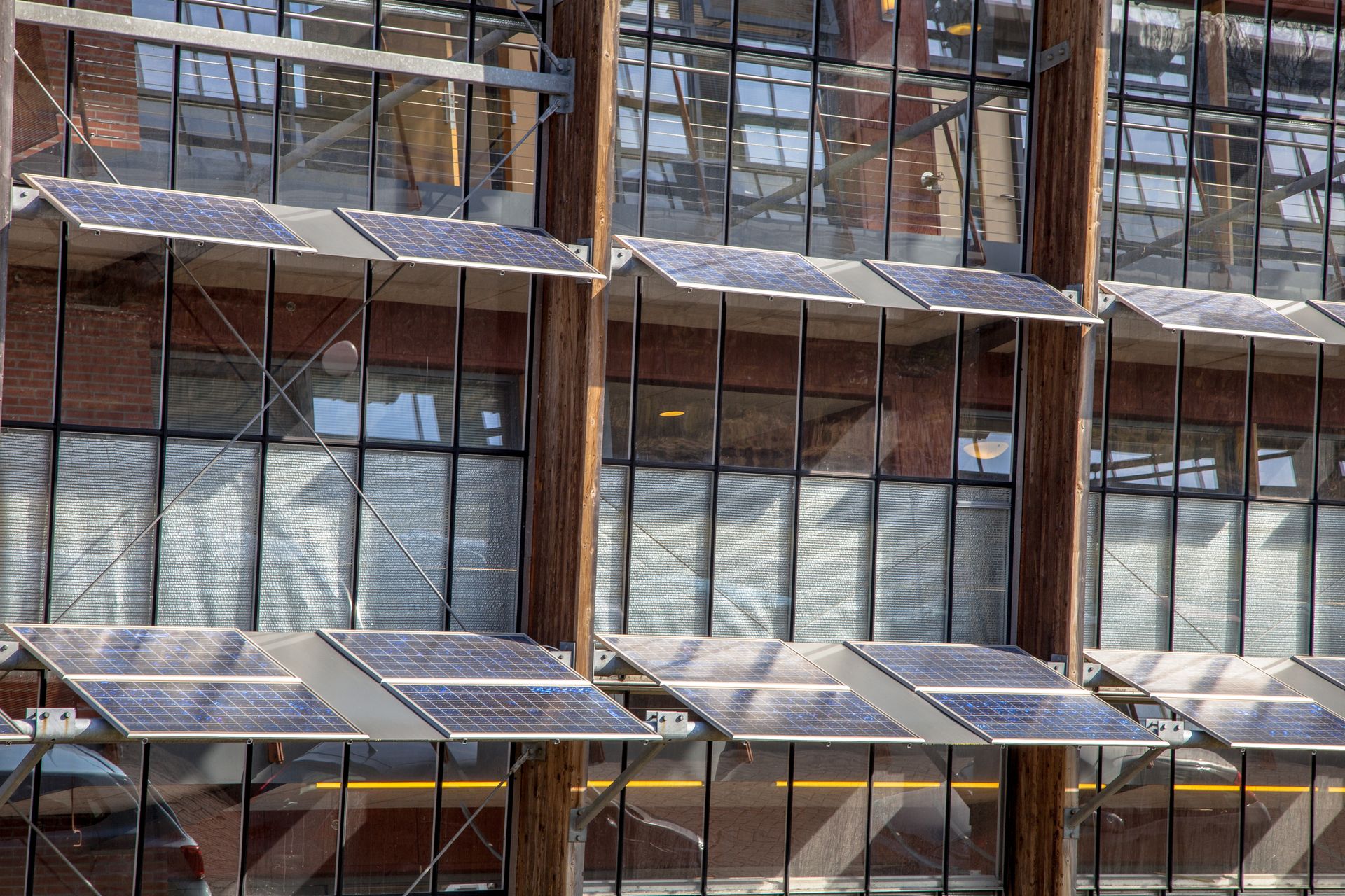 Shutters and solar panels shading the outside of a building.