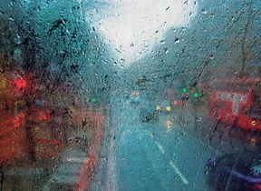 street-through-rainy-bus-window