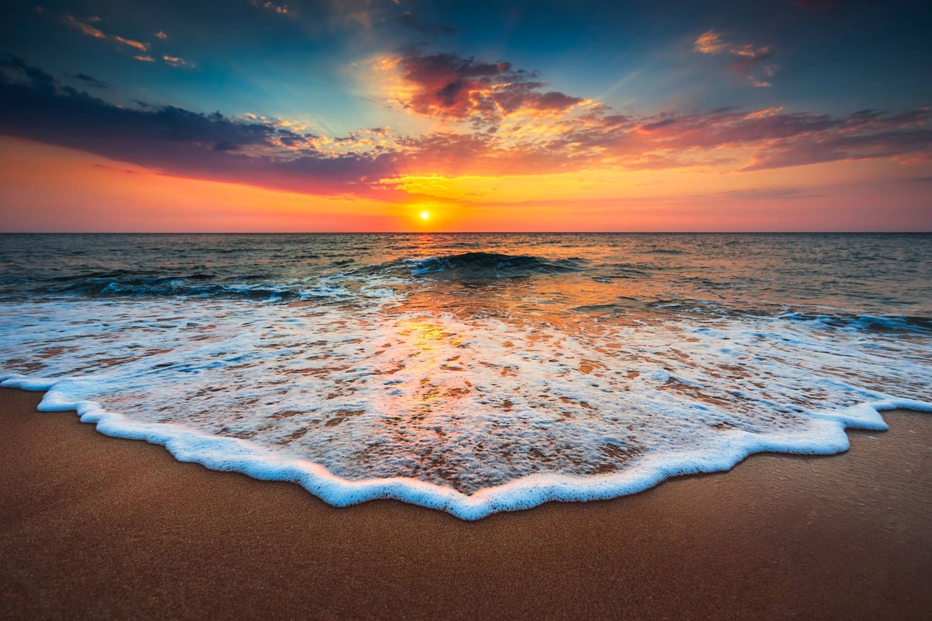 Orange sunset over the sea with whispy