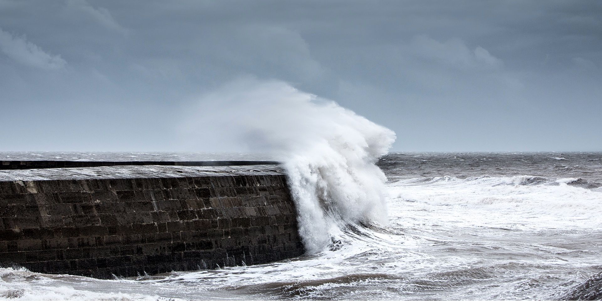 waves-crashing-against-a-harbour-wall