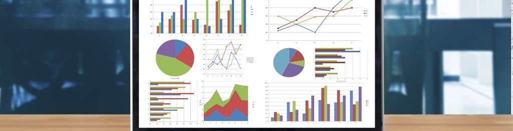 A laptop computer screen displaying charts.