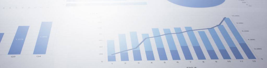 A series of blue charts and graphs, slightly out of focus