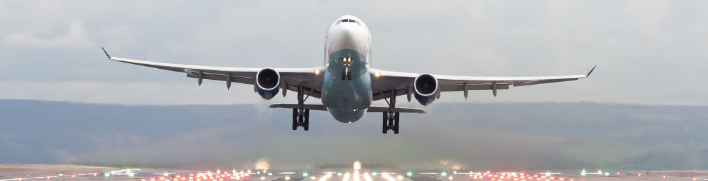 A plane taking off from an airport runway.