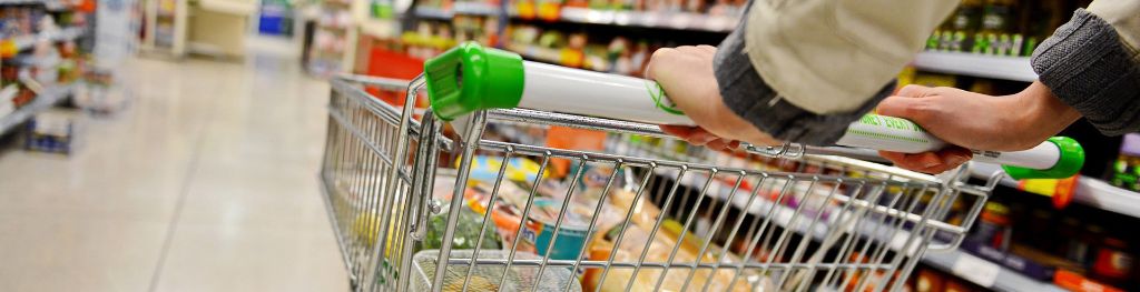 A man pushing a trolley in a supermarket.