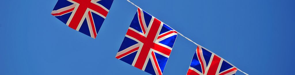 Bunting of British flags against a bright blue sky