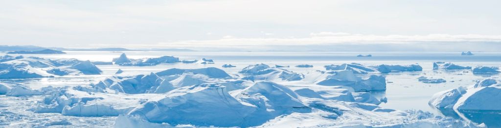 arctic ice and ice sheets on sea water in bright sunshine