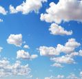 Fluffy white cumulus cloud on a dark blue sky
