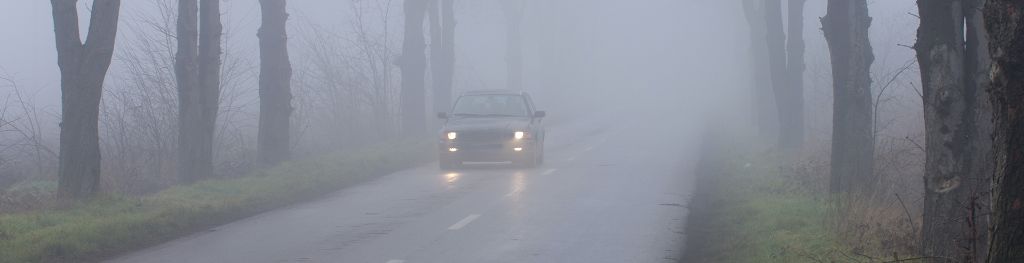 Car driving in fog