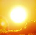 Sunshine over clouds in an orange sky during a heatwave.