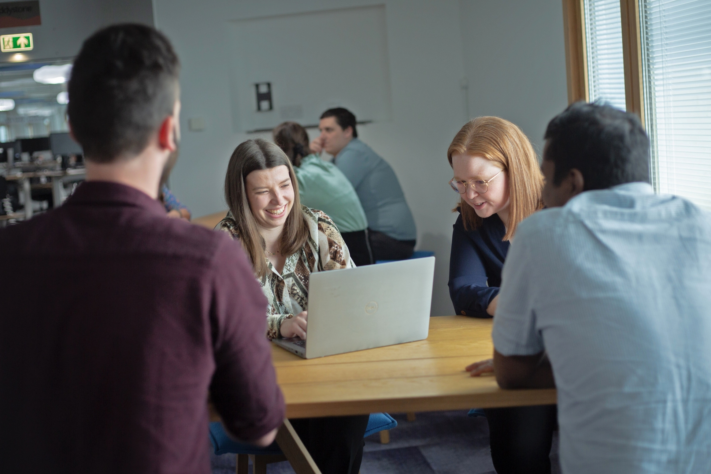 The image shows a group of people working together