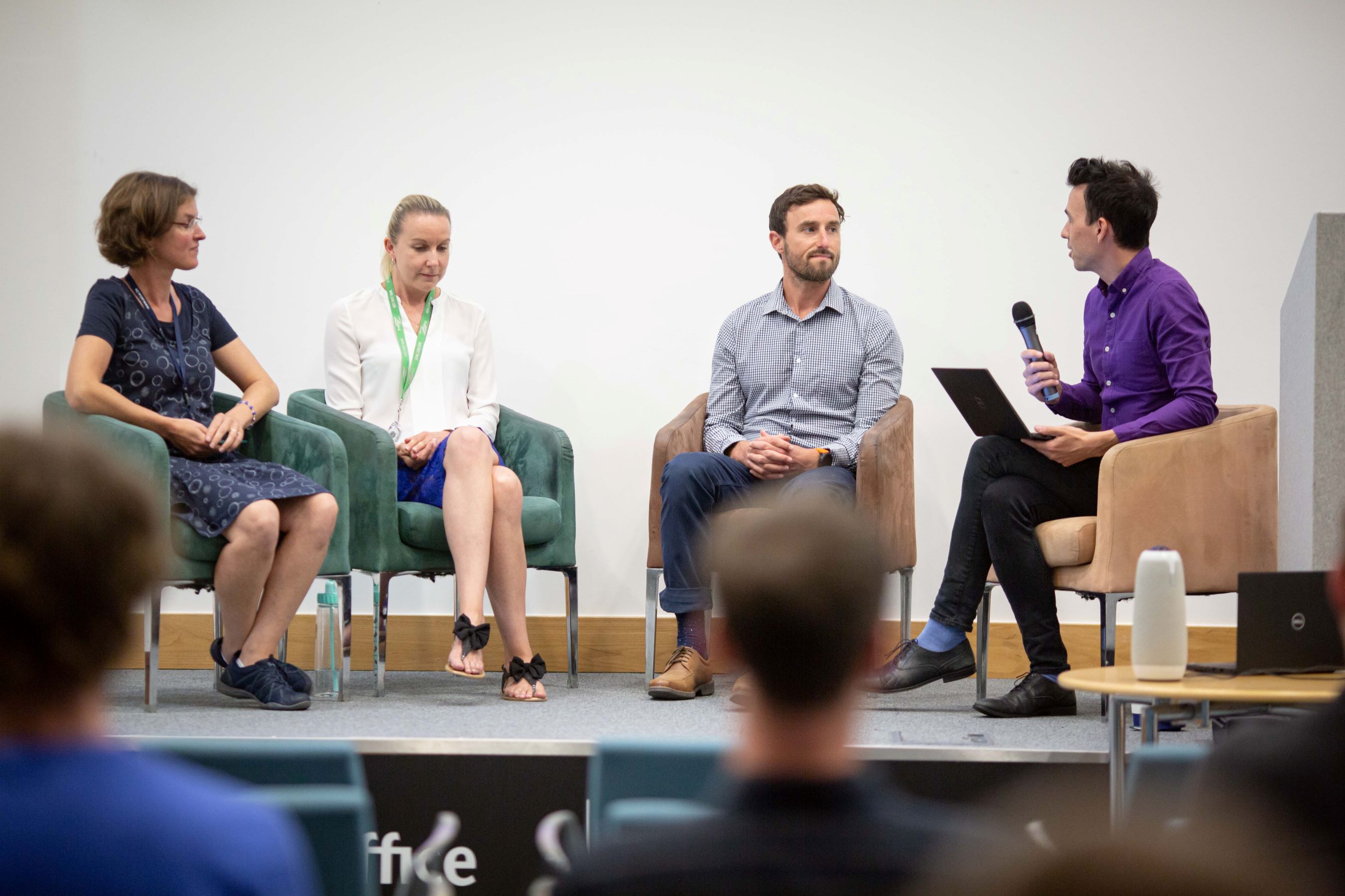 Presenter Aidan Mcgiven posing questions to three Met Office scientists at the Science Fair