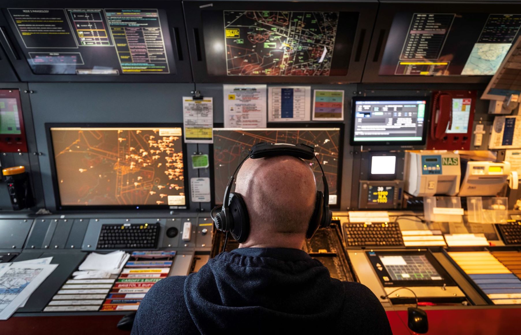 Staff member at the controls in National Air Traffic Service centre
