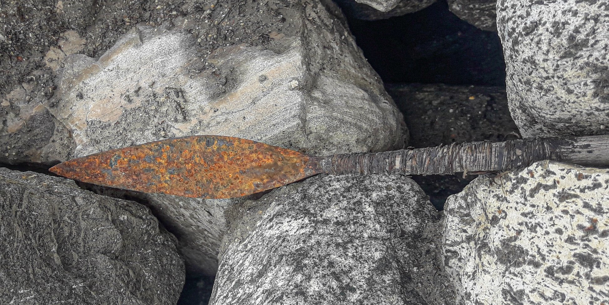 An arrowhead from 500 AD on top of some rocks.