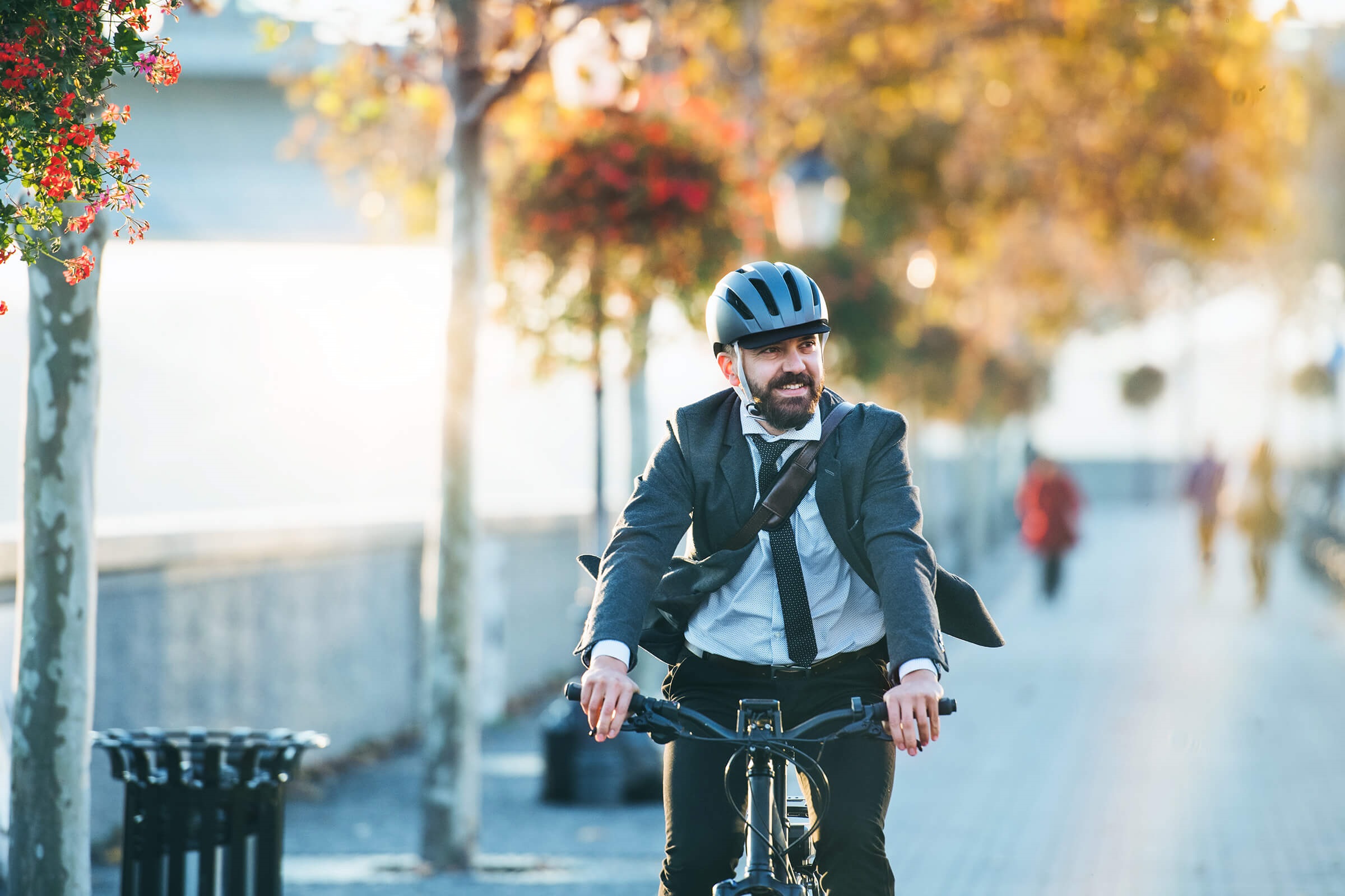 Man on a bike wearing a suit.