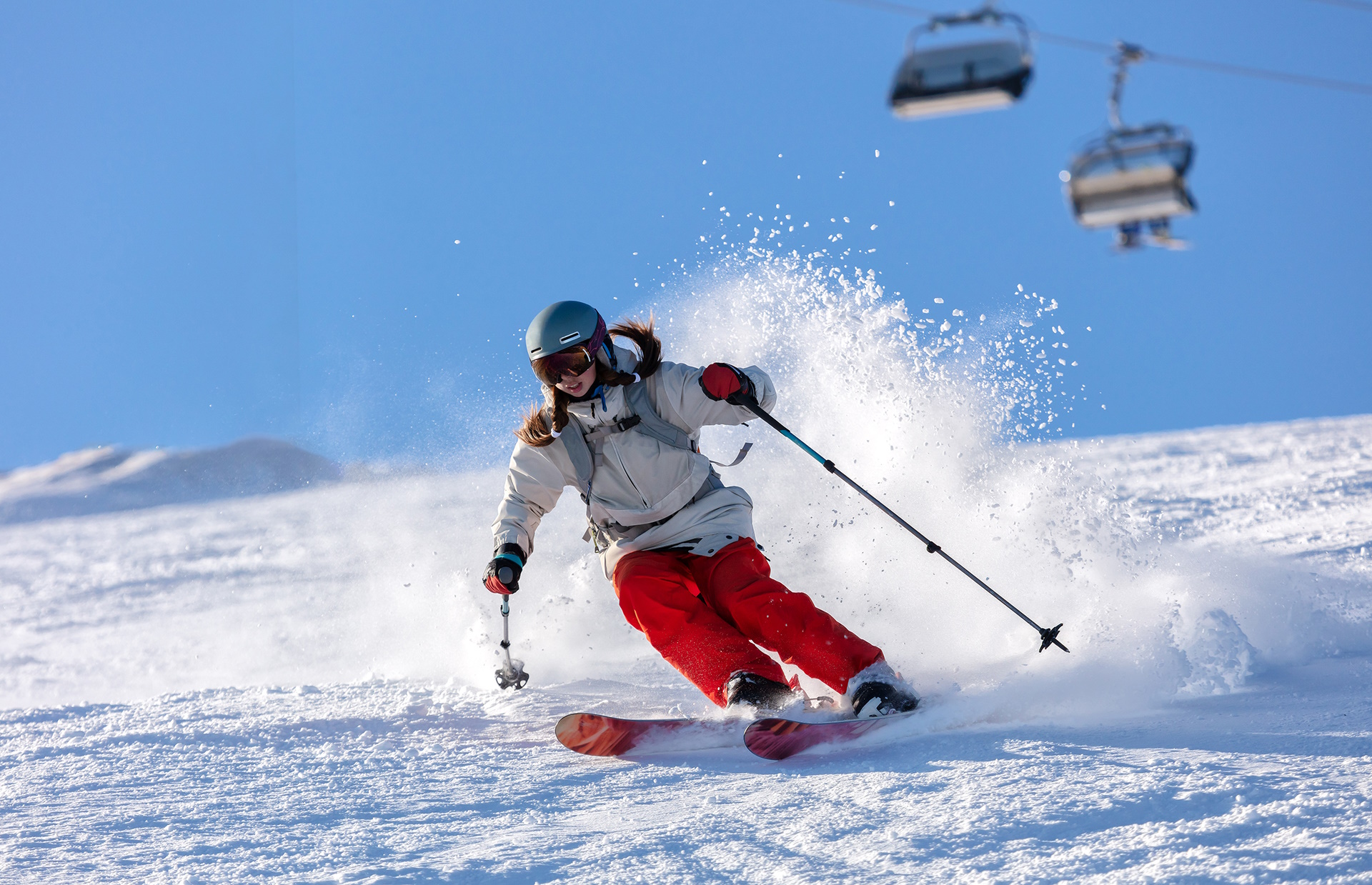A woman skiing down a snow covered slope.
