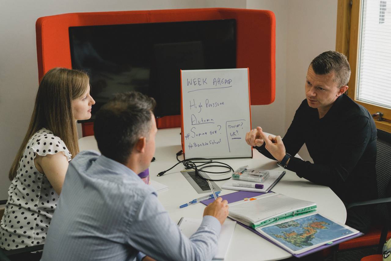 Three people being trained on meteorology