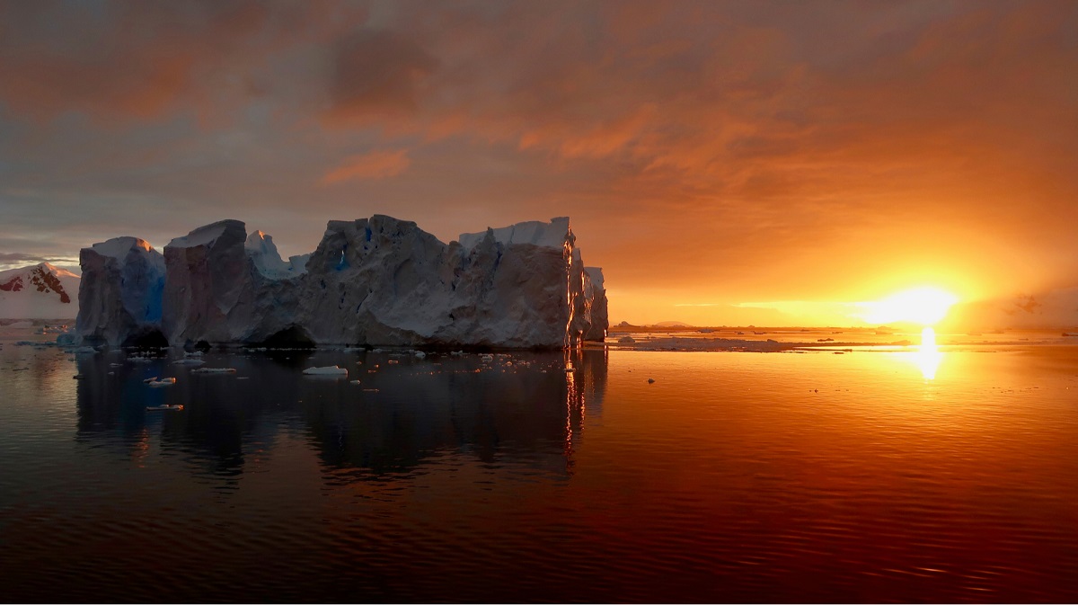 Sun setting over an iceberg in Antarctica.