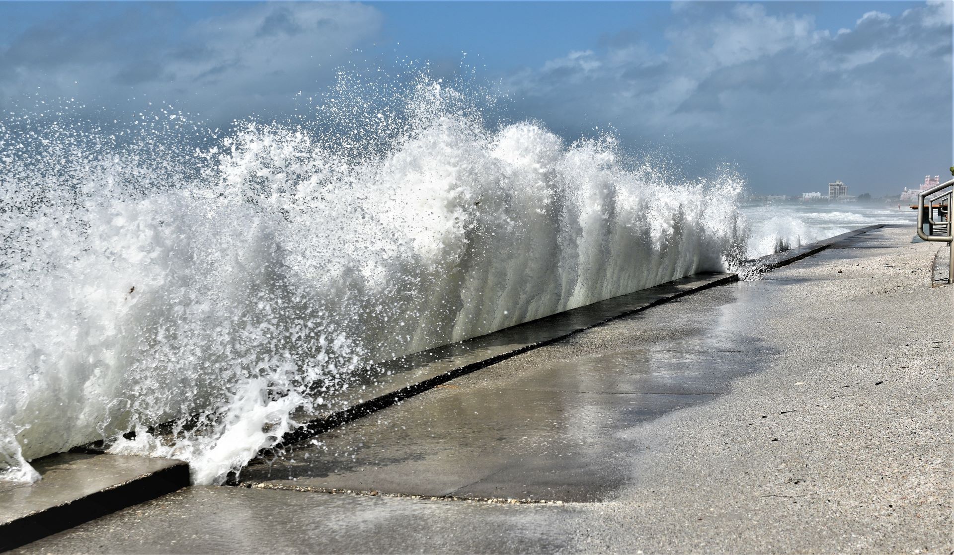 Decorative image showing waves splashing on a pavement