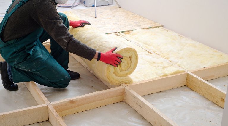 Person laying loft insulation